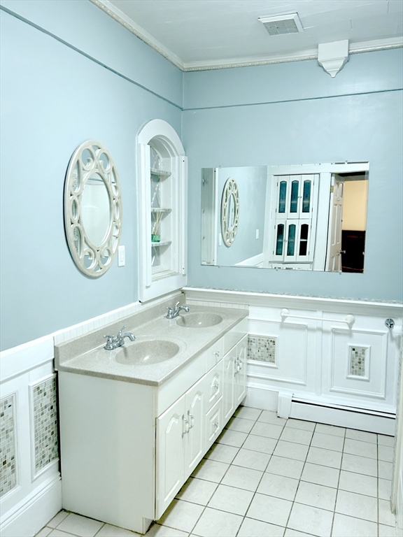 25 Baltimore Street, Unit 2/3 Lynn, MA 01902 - Photo 15 of 36 a spacious bathroom with a granite countertop sink and a mirror