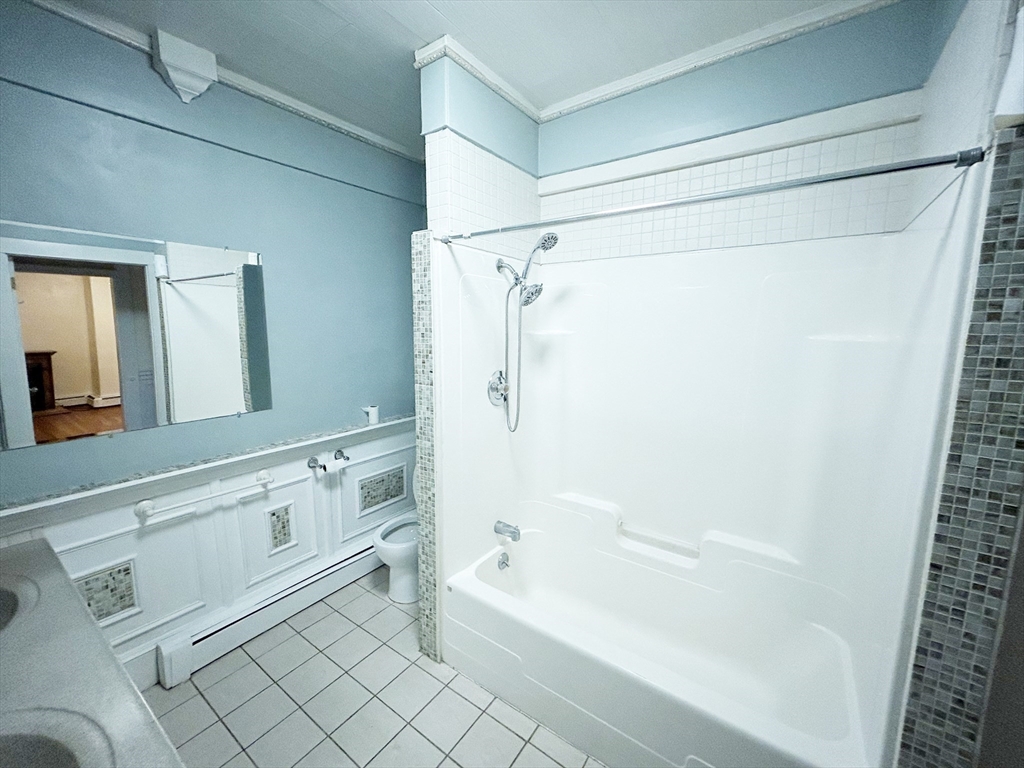 25 Baltimore Street, Unit 2/3 Lynn, MA 01902 - Photo 16 of 36 a bathroom with a bathtub and a shower