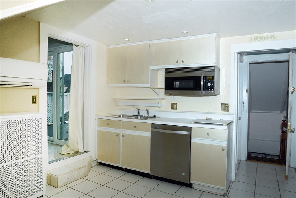 25 Baltimore Street, Unit 2/3 Lynn, MA 01902 - Photo 20 of 36 a kitchen with a sink stove and cabinets