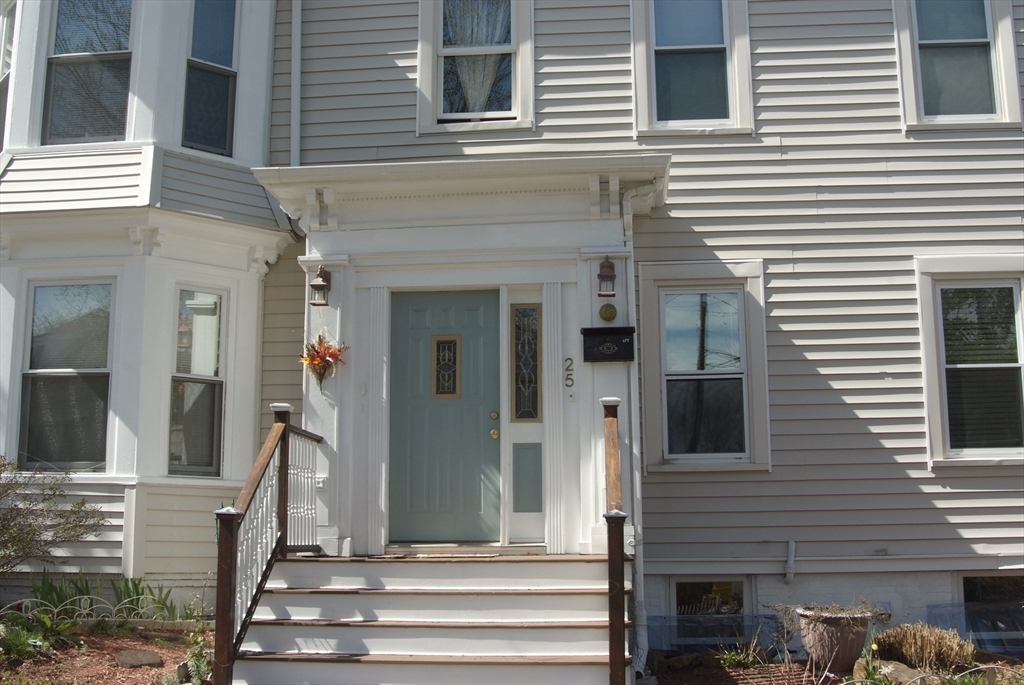 25 Baltimore Street, Unit 2/3 Lynn, MA 01902 - Photo 2 of 36 a front view of a house with a garden