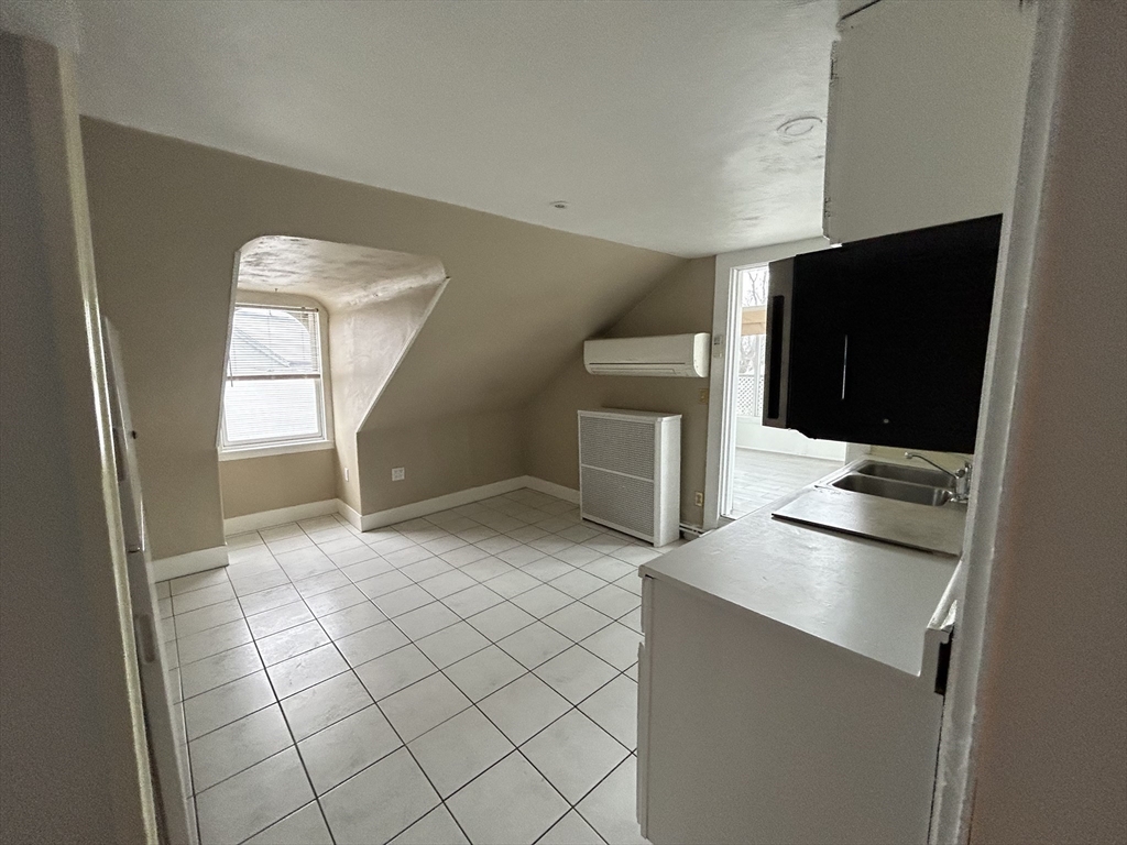 25 Baltimore Street, Unit 2/3 Lynn, MA 01902 - Photo 21 of 36 a kitchen with stainless steel appliances a sink and a stove