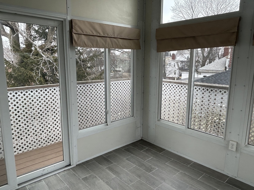25 Baltimore Street, Unit 2/3 Lynn, MA 01902 - Photo 33 of 36 a view of empty room with wooden floor and floor to ceiling window