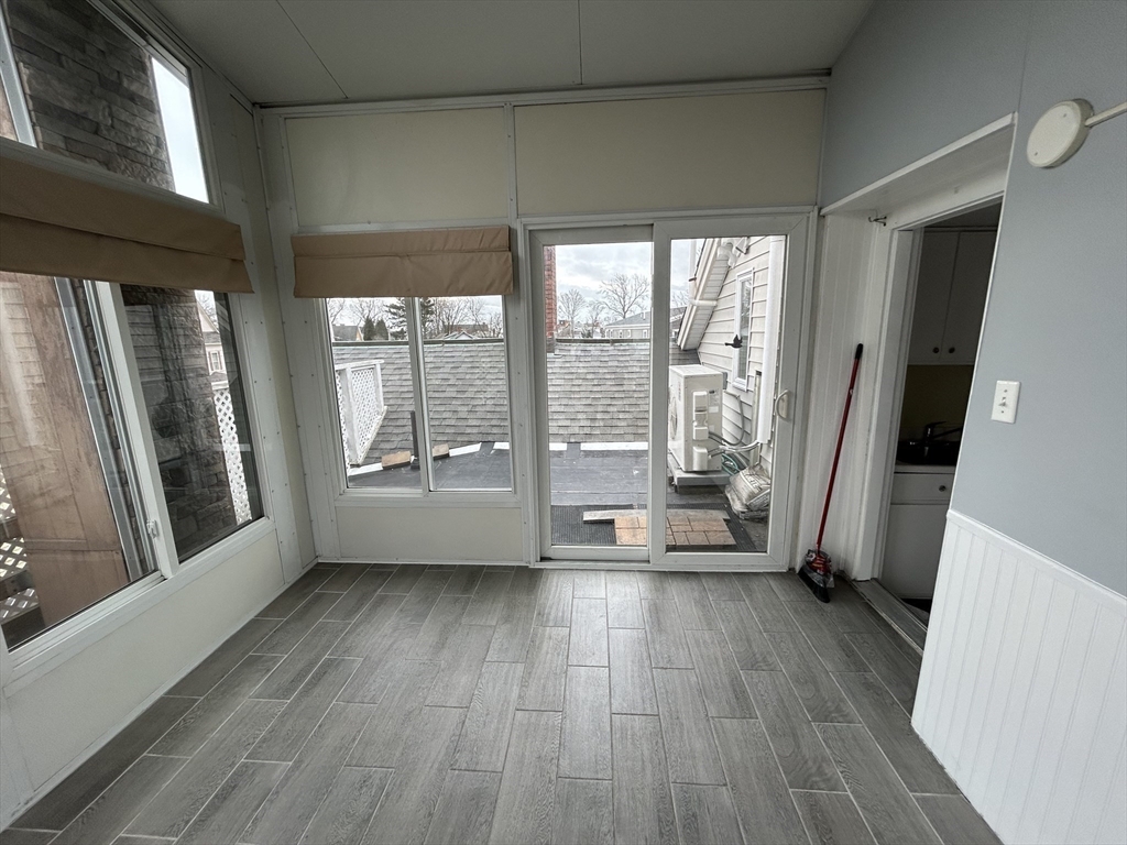 25 Baltimore Street, Unit 2/3 Lynn, MA 01902 - Photo 34 of 36 a view of an empty room with a window and wooden floor