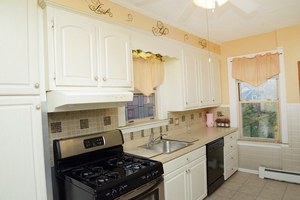 25 Baltimore Street, Unit 2/3 Lynn, MA 01902 - Photo 6 of 36 a kitchen with a sink stove and cabinets