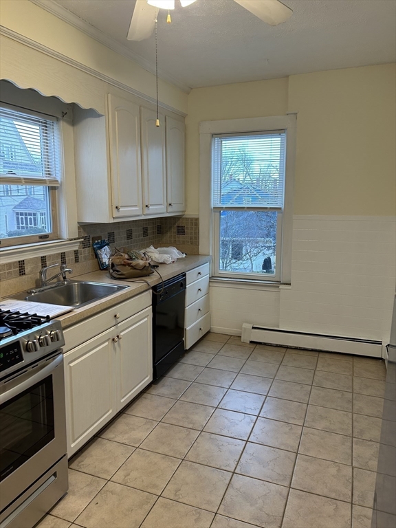 25 Baltimore Street, Unit 2/3 Lynn, MA 01902 - Photo 7 of 36 a kitchen with a stove a sink and a refrigerator