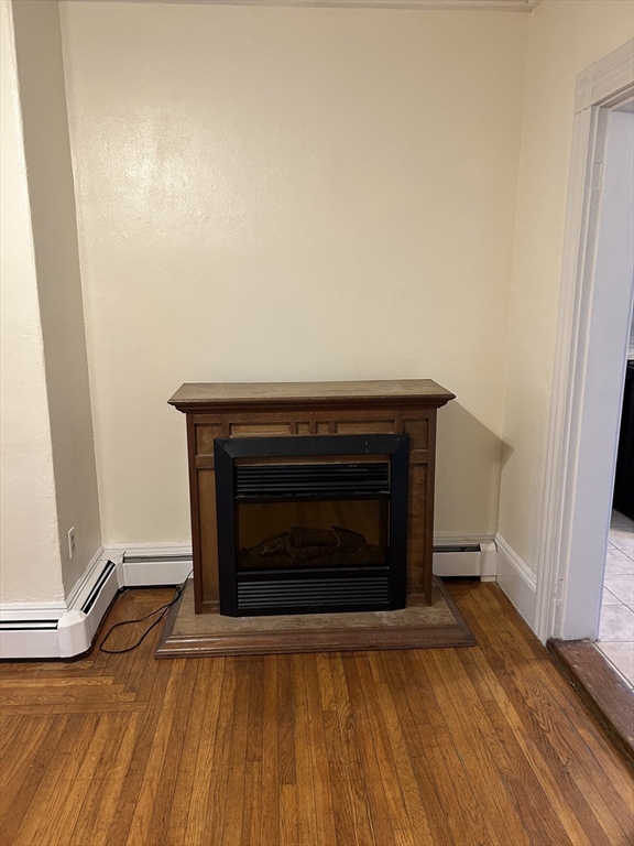 25 Baltimore Street, Unit 2/3 Lynn, MA 01902 - Photo 10 of 36 a room with a fireplace and a rug