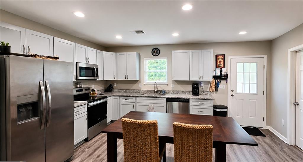 2956 Westmoreland Road Cleveland, GA 30528 - Photo 6 of 22 a kitchen with stainless steel appliances granite countertop a refrigerator a stove microwave and cabinets