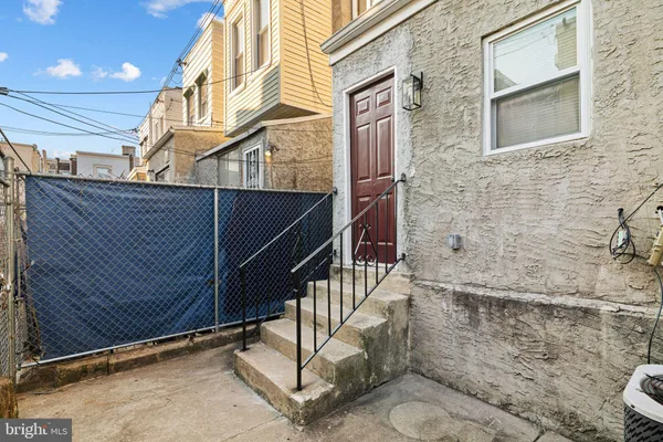 a view of front door of house with wooden stairs