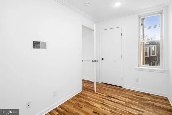 a view of a room with wooden floor and cabinet