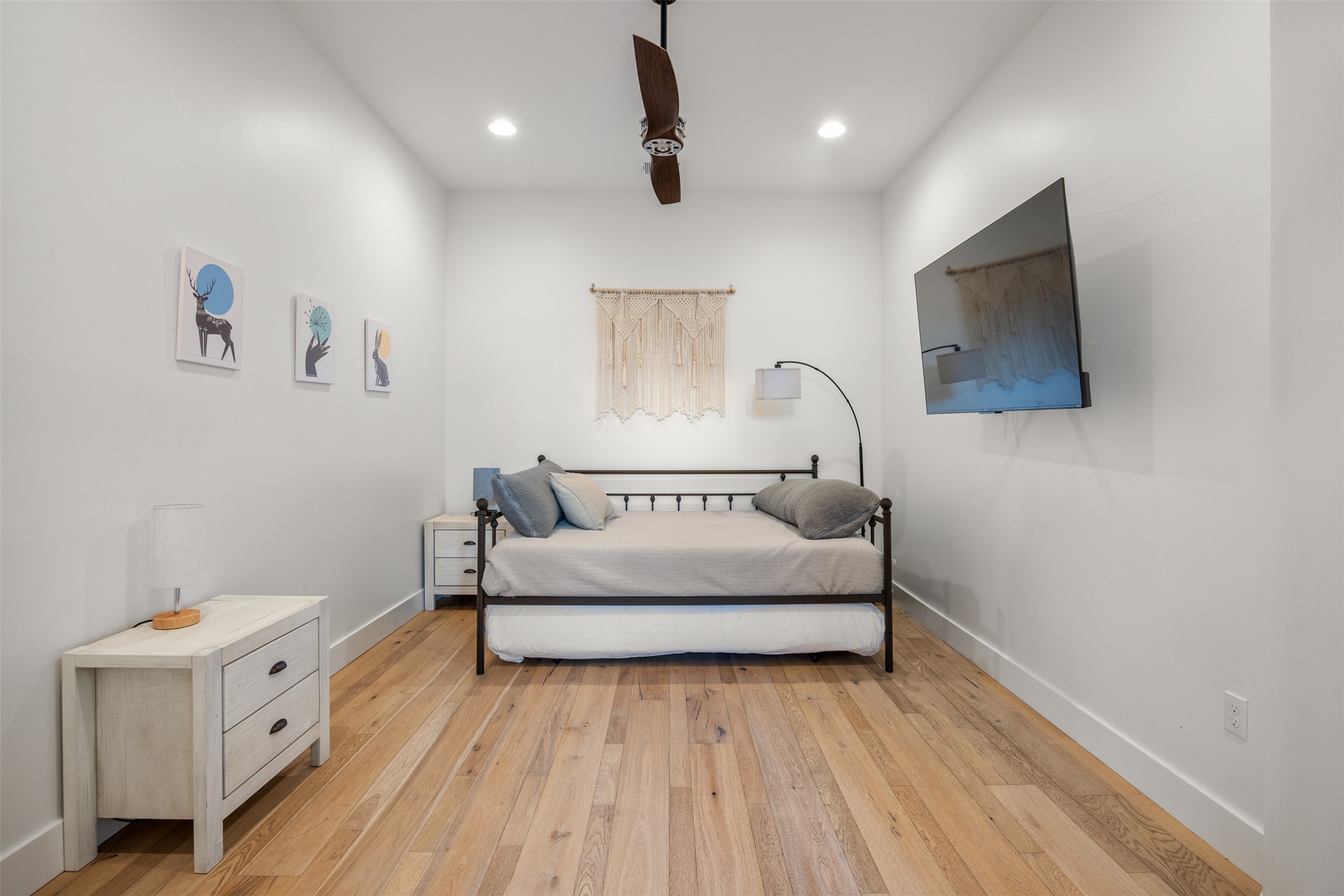 4103 Ridgelea Drive Austin, TX 78731 - Photo 22 of 26 Hardwood floors and a ceiling fan create a comfortable and inviting atmosphere in this bedroom.
