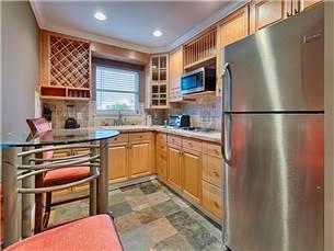 58 Sunfish Street Destin, FL 32541 - Photo 20 of 32 a kitchen with stainless steel appliances a refrigerator sink and cabinets