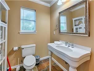 58 Sunfish Street Destin, FL 32541 - Photo 23 of 32 a bathroom with a sink a toilet and a mirror