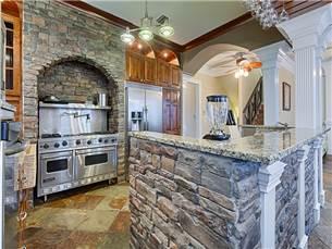 58 Sunfish Street Destin, FL 32541 - Photo 9 of 32 a kitchen with stainless steel appliances granite countertop a stove and cabinets