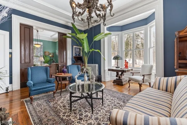 a living room with furniture a fireplace and a large window