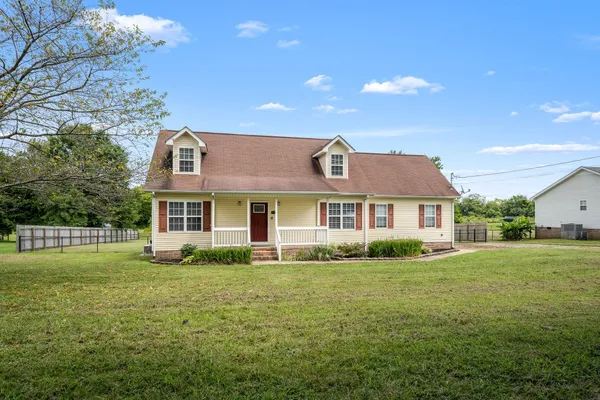a front view of a house with a yard