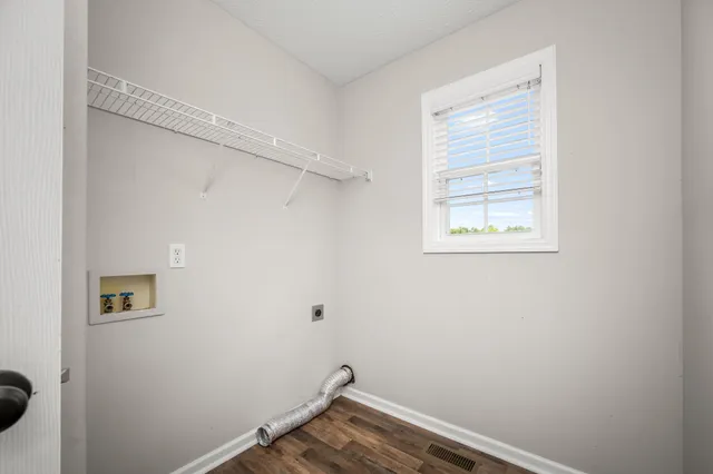 a view of small space with wooden floor and closet