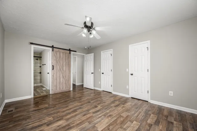 a view of an empty room with wooden floor