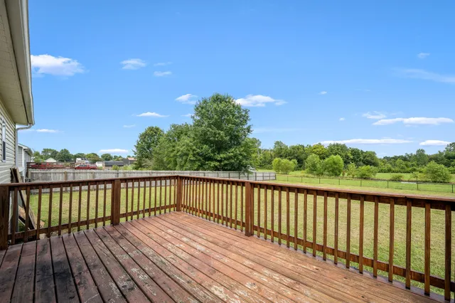 a view of balcony with wooden floor and fence