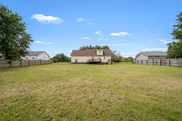 a view of a field with table and chairs