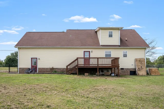a front view of a house with a garden and deck
