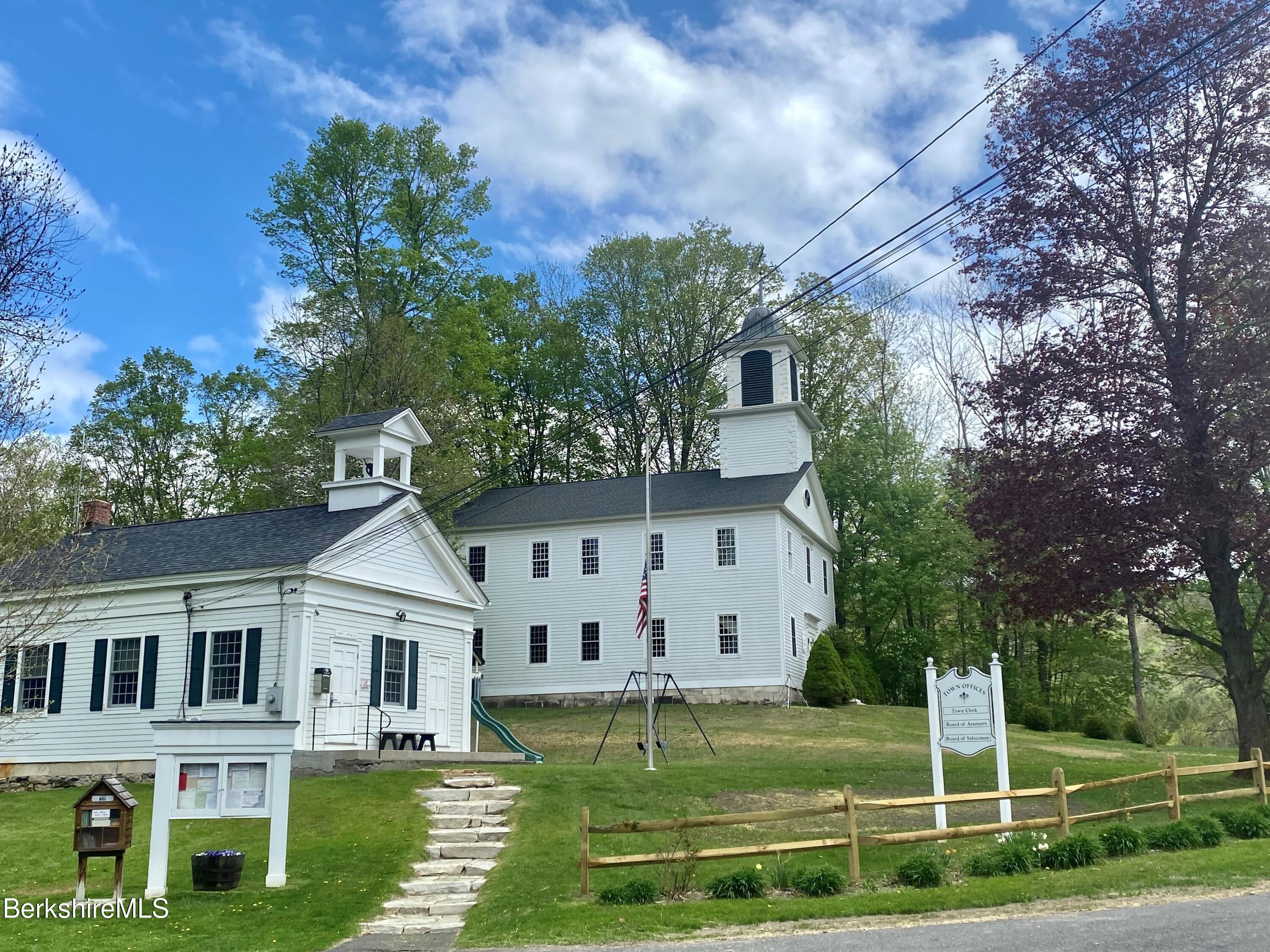 15 W Road Alford, MA 01266 - Photo 63 of 64 a view of a white house with a big yard and potted plants and large trees