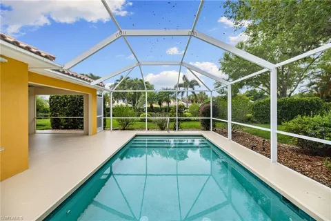 a view of a backyard with swimming pool