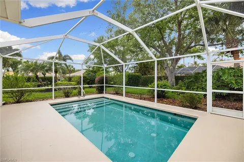 a view of a backyard with a swimming pool