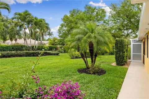 a view of yard with swimming pool and green space