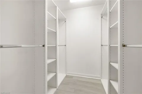a view of an empty walk in closet with empty racks
