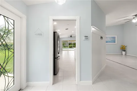 a view of a hallway with bathroom and glass door