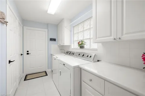 a bathroom with a double vanity sink toilet mirror and shower