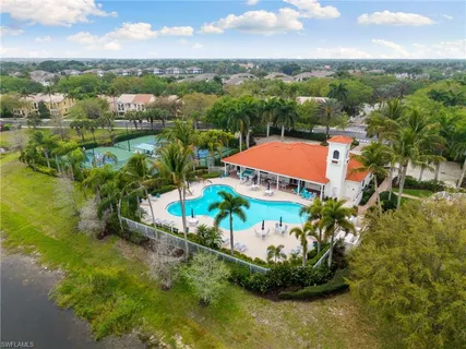 an aerial view of residential houses with outdoor space and swimming pool