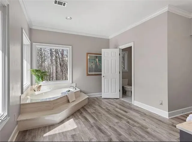 a spacious bedroom with a bed and a window