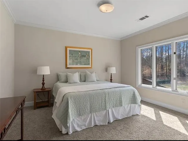 a bedroom with a bed and glass window