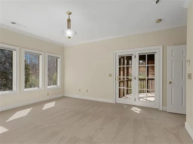 a view of an empty room with a window and balcony