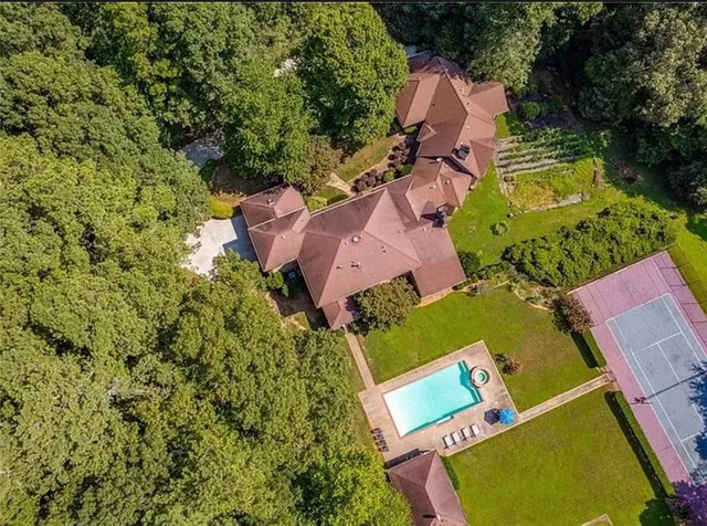 an aerial view of house with yard swimming pool and outdoor seating