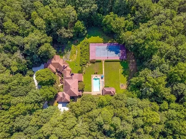 an aerial view of residential house with outdoor space and swimming pool