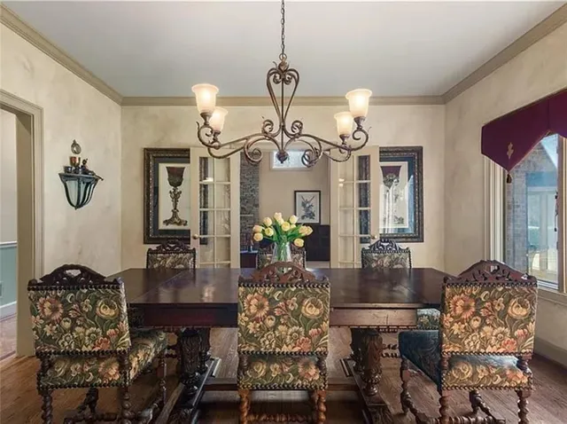 a view of a dining room with furniture and chandelier
