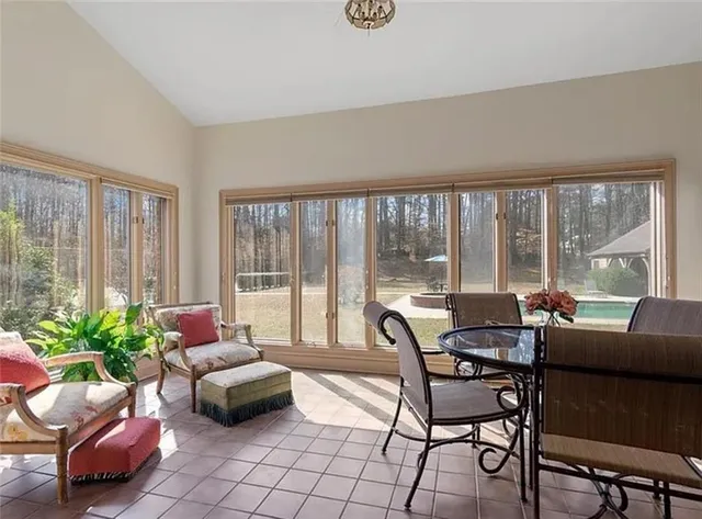 a living room with furniture and floor to ceiling windows