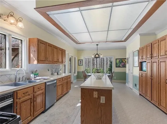 a kitchen with stainless steel appliances a sink dishwasher stove and refrigerator