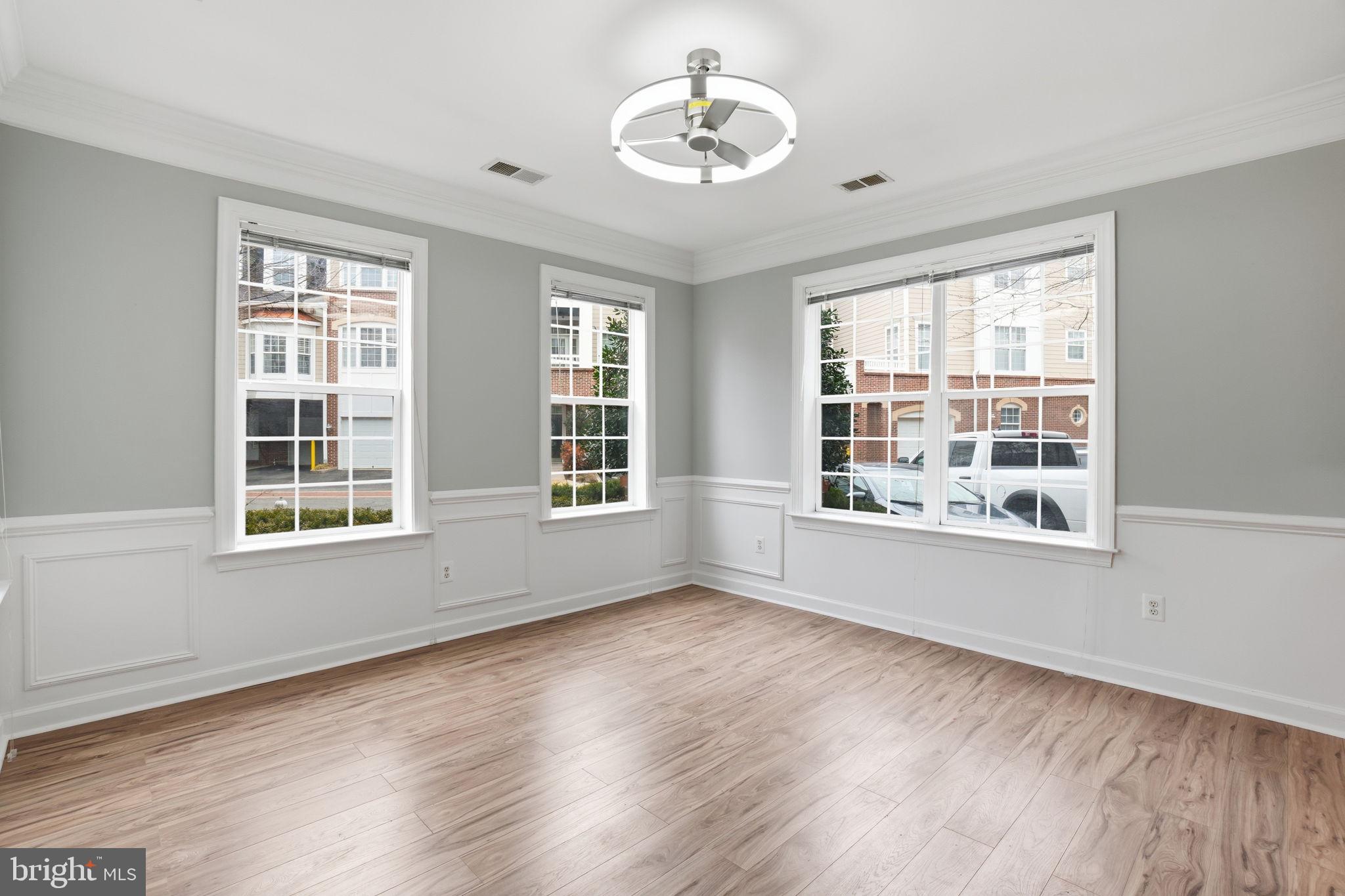 7871 Rolling Woods Court, Unit 1104 Springfield, VA 22152 - Photo 12 of 38 a view of an empty room with wooden floor and a window
