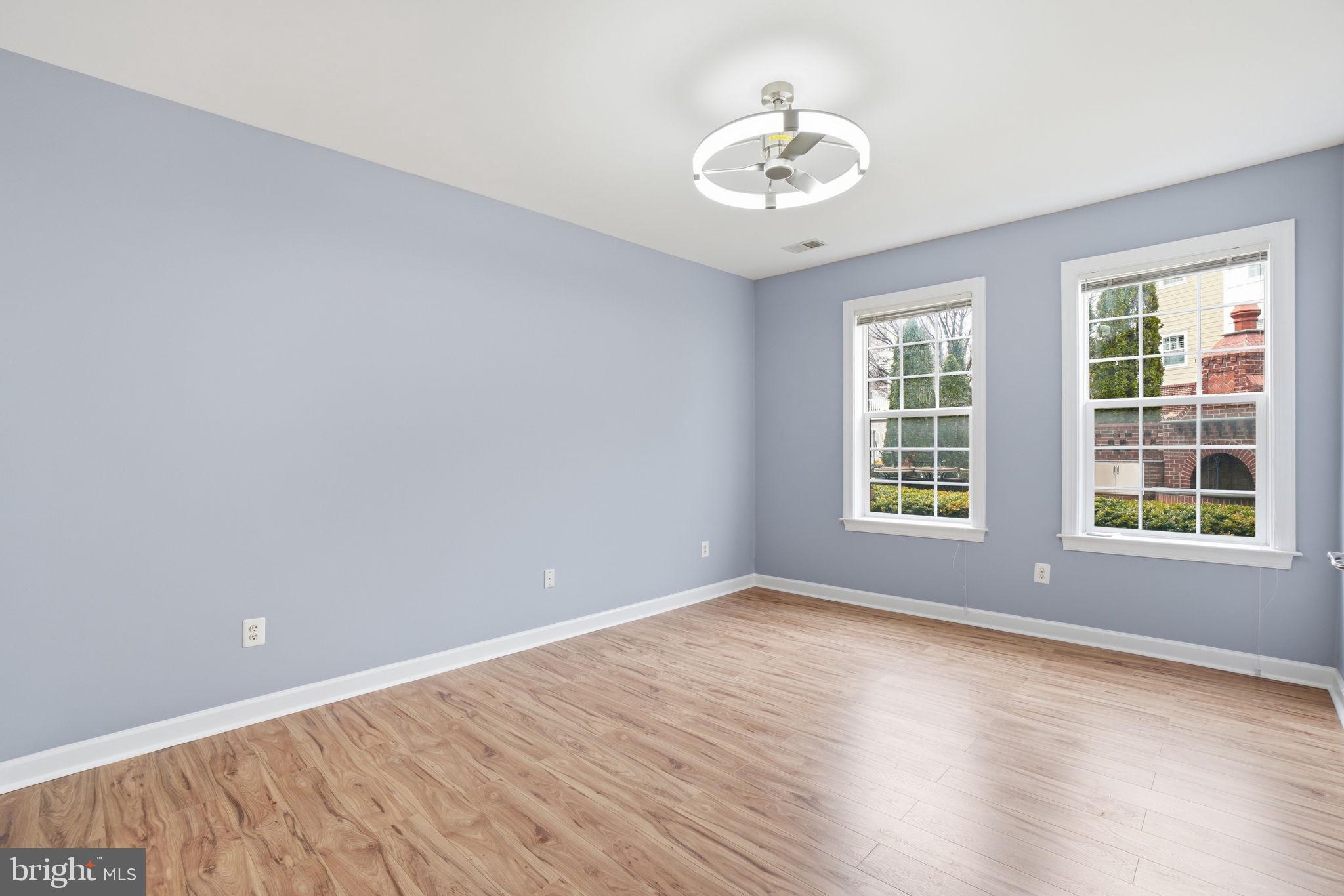 7871 Rolling Woods Court, Unit 1104 Springfield, VA 22152 - Photo 16 of 38 wooden floor in an empty room with a window