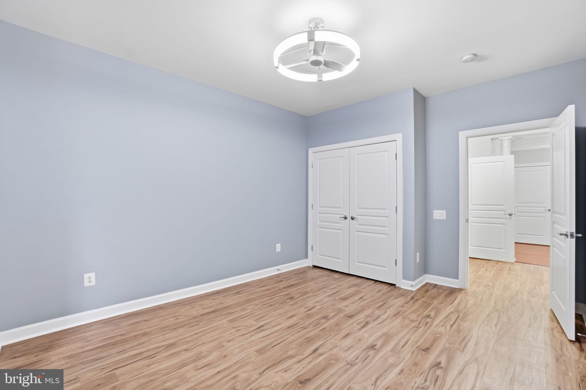 7871 Rolling Woods Court, Unit 1104 Springfield, VA 22152 - Photo 19 of 38 wooden floor in an empty room