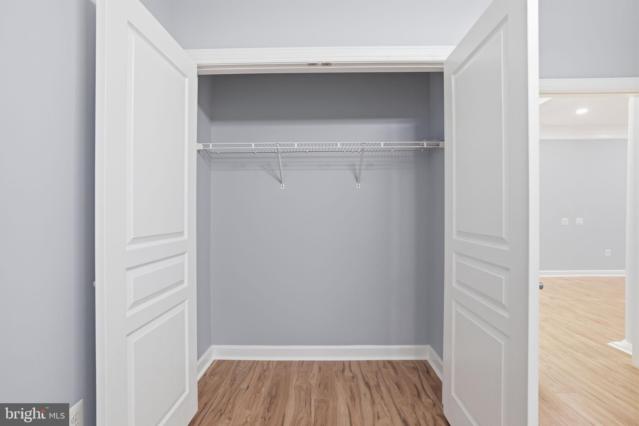 7871 Rolling Woods Court, Unit 1104 Springfield, VA 22152 - Photo 21 of 38 a view of walk in closet with wooden floor