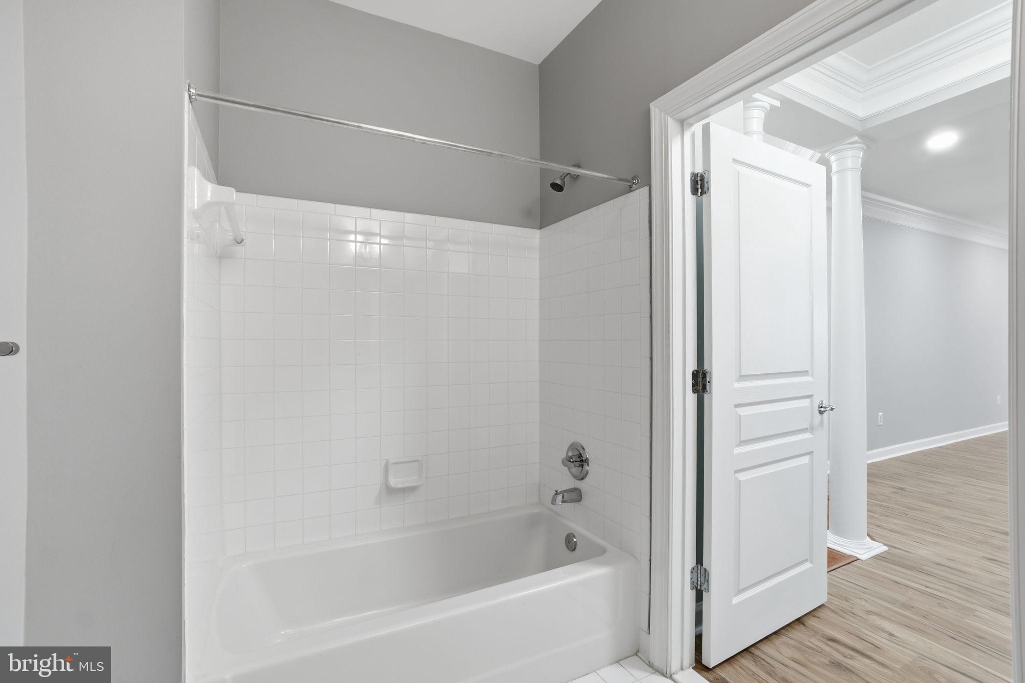 7871 Rolling Woods Court, Unit 1104 Springfield, VA 22152 - Photo 22 of 38 a bathroom with a bathtub and a shower