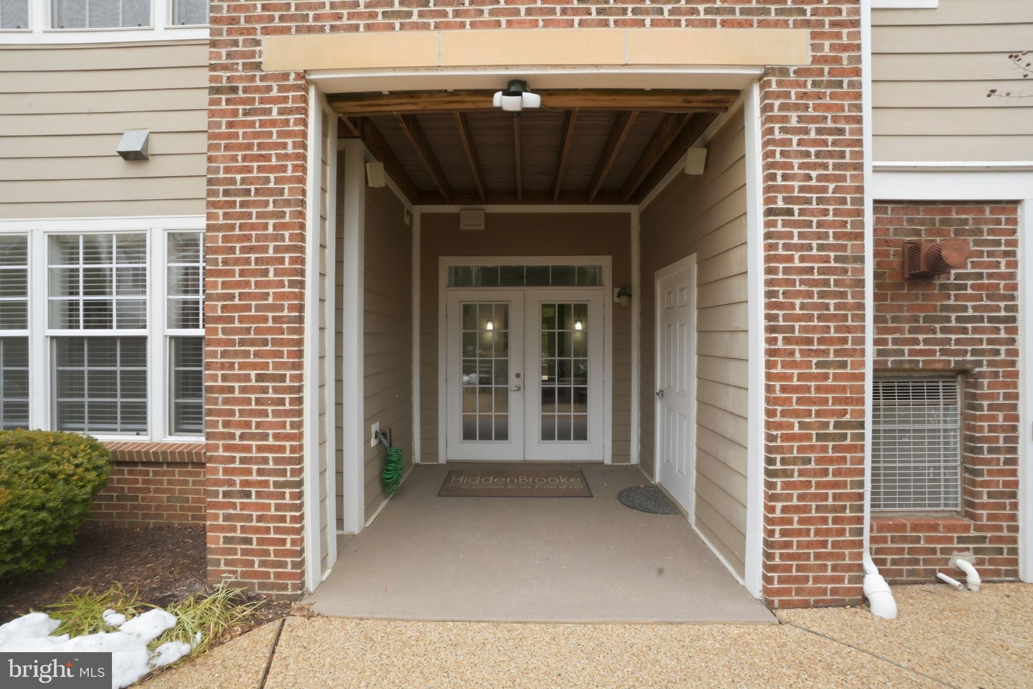 7871 Rolling Woods Court, Unit 1104 Springfield, VA 22152 - Photo 3 of 38 a front view of a house with a garage