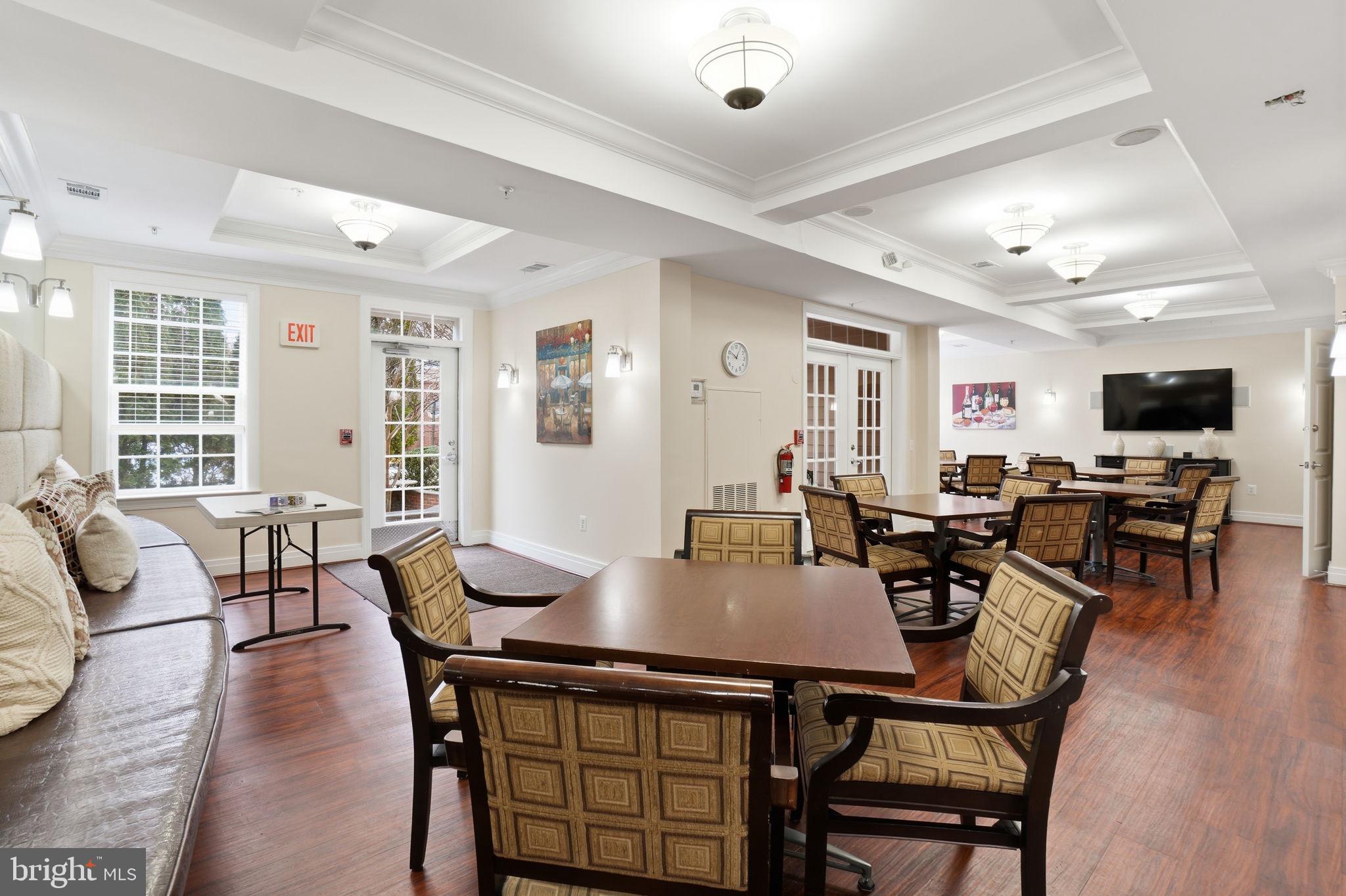 7871 Rolling Woods Court, Unit 1104 Springfield, VA 22152 - Photo 5 of 38 a view of a dining room with furniture and wooden floor
