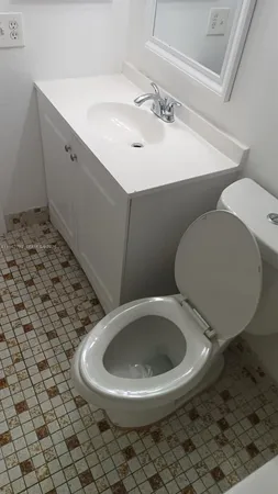 a bathroom with a toilet and a shower