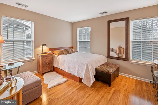 a bedroom with two beds and a large window