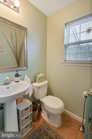 a bathroom with a sink toilet and mirror